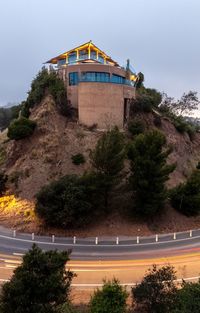 Building by road against sky