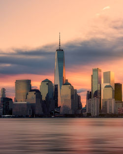 Buildings in city against sky during sunrise