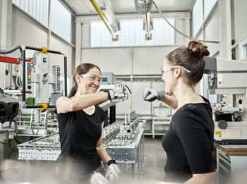 Two women at work, fist bump