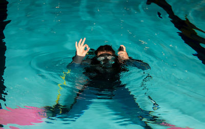 High angle view of boy swimming in pool