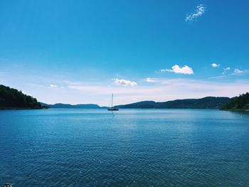 Scenic view of sea against blue sky