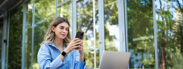 Young woman using mobile phone