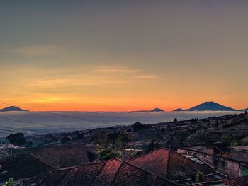 Aerial view of townscape against sky during sunset