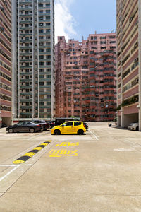 Vehicles on road against buildings in city