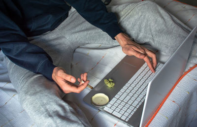 Midsection of man using mobile phone