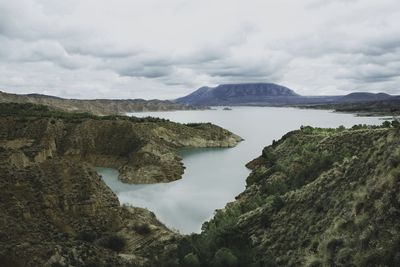 Scenic view of sea and mountains against sky