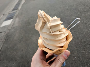 Soy sauce soft serve ice cream in a cone.