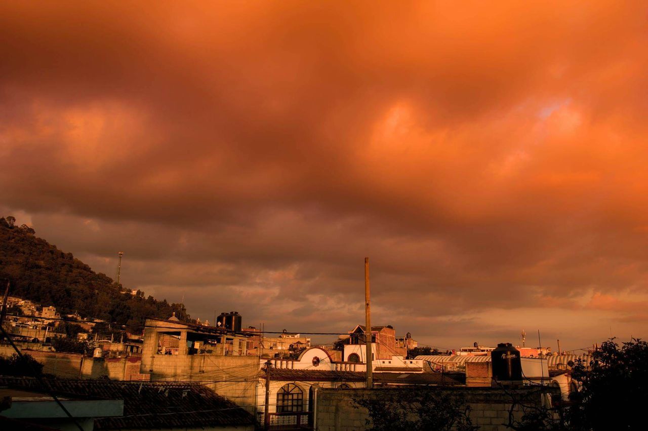 building exterior, architecture, built structure, sunset, sky, cloud - sky, cloudy, house, weather, overcast, residential structure, orange color, residential building, dramatic sky, city, storm cloud, tree, cloud, dusk, residential district