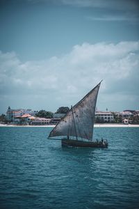 Sailboat sailing in sea against sky