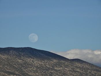 Low angle view of mountain against blue sky