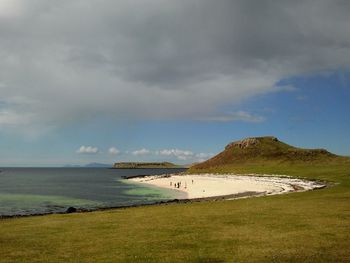 Scenic view of beach under stormy sky