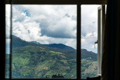 Scenic view of mountains seen through window