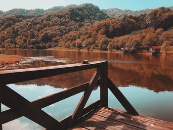 Scenic view of lake by trees against sky