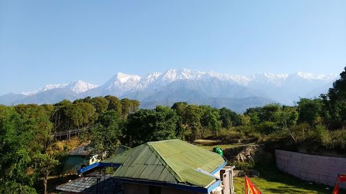 Panoramic view of trees and mountains against clear sky