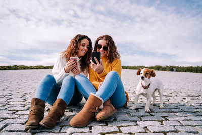 Young woman with dog sitting outdoors