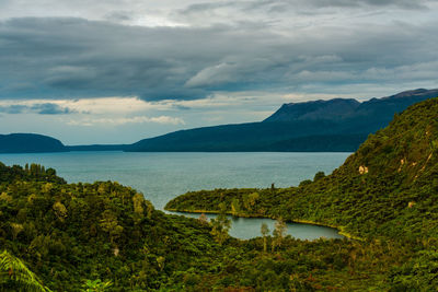 Scenic view of lake and mountains against sky