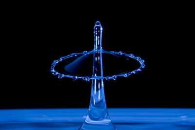 Close-up of water drops on glass against black background