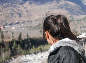 Side view of woman looking at mountains