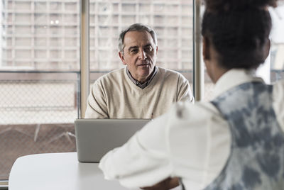 Businessman and young woman in conference room