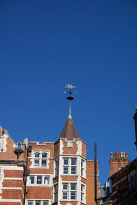 Low angle view of buildings against blue sky