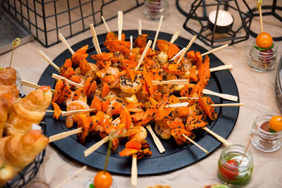 Shrimp sweet potato kebab in black sesame seeds on slate plate