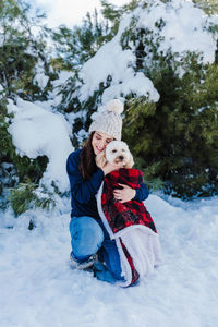 Woman with dog in snow