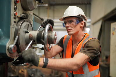 Portrait of male worker standing in the heavy industry manufacturing factory.