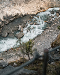 High angle view of stream flowing through rocks