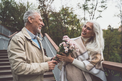 Happy couple holding hands outdoors