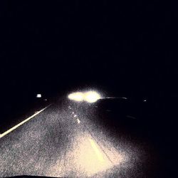 Illuminated tunnel at night