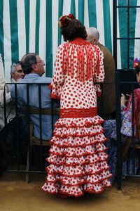 Rear view of people standing at home