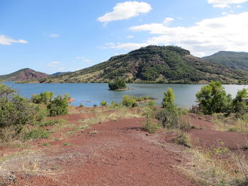 Scenic view of lake and mountains against sky