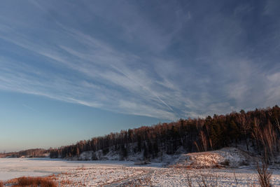 Scenic view of snow covered land against sky