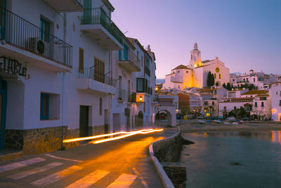 Illuminated buildings in city at dusk