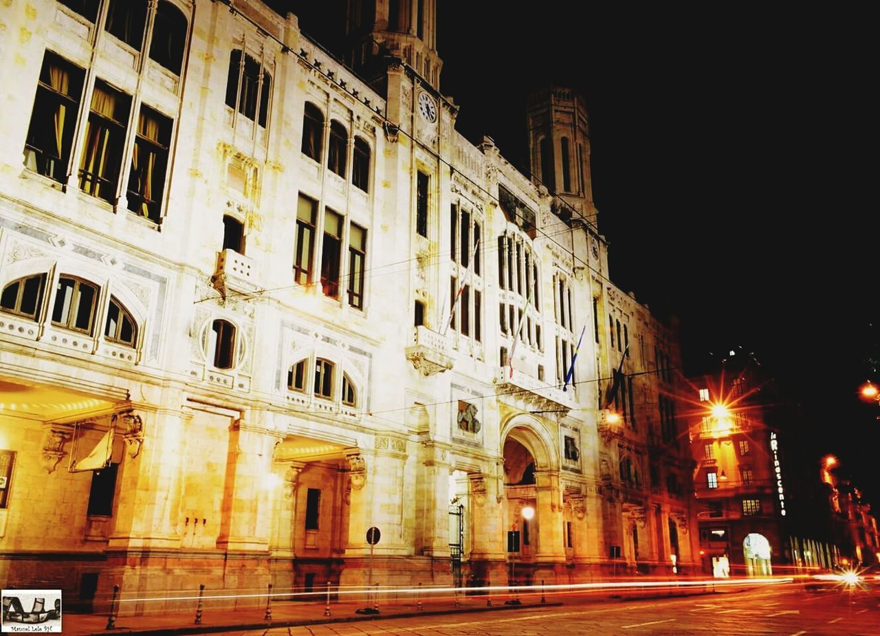 VIEW OF ILLUMINATED STREET AT NIGHT