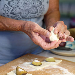 Cropped hand of person preparing food