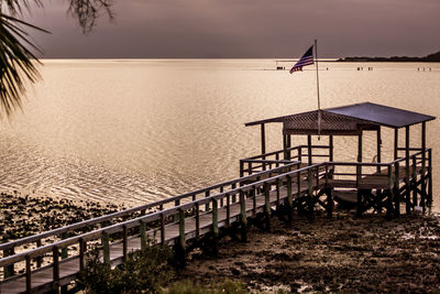 Lifeguard hut against sky during sunset