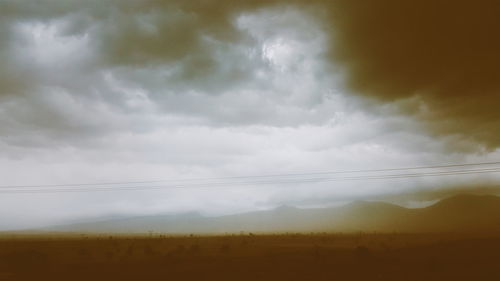 Scenic view of landscape against cloudy sky