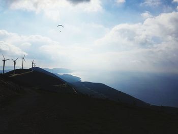 Scenic view of sea and mountains against sky