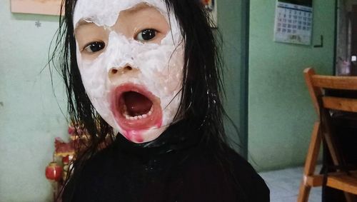 Close-up portrait of girl at home