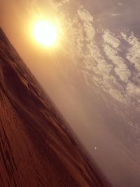 Scenic view of sand dunes against sky