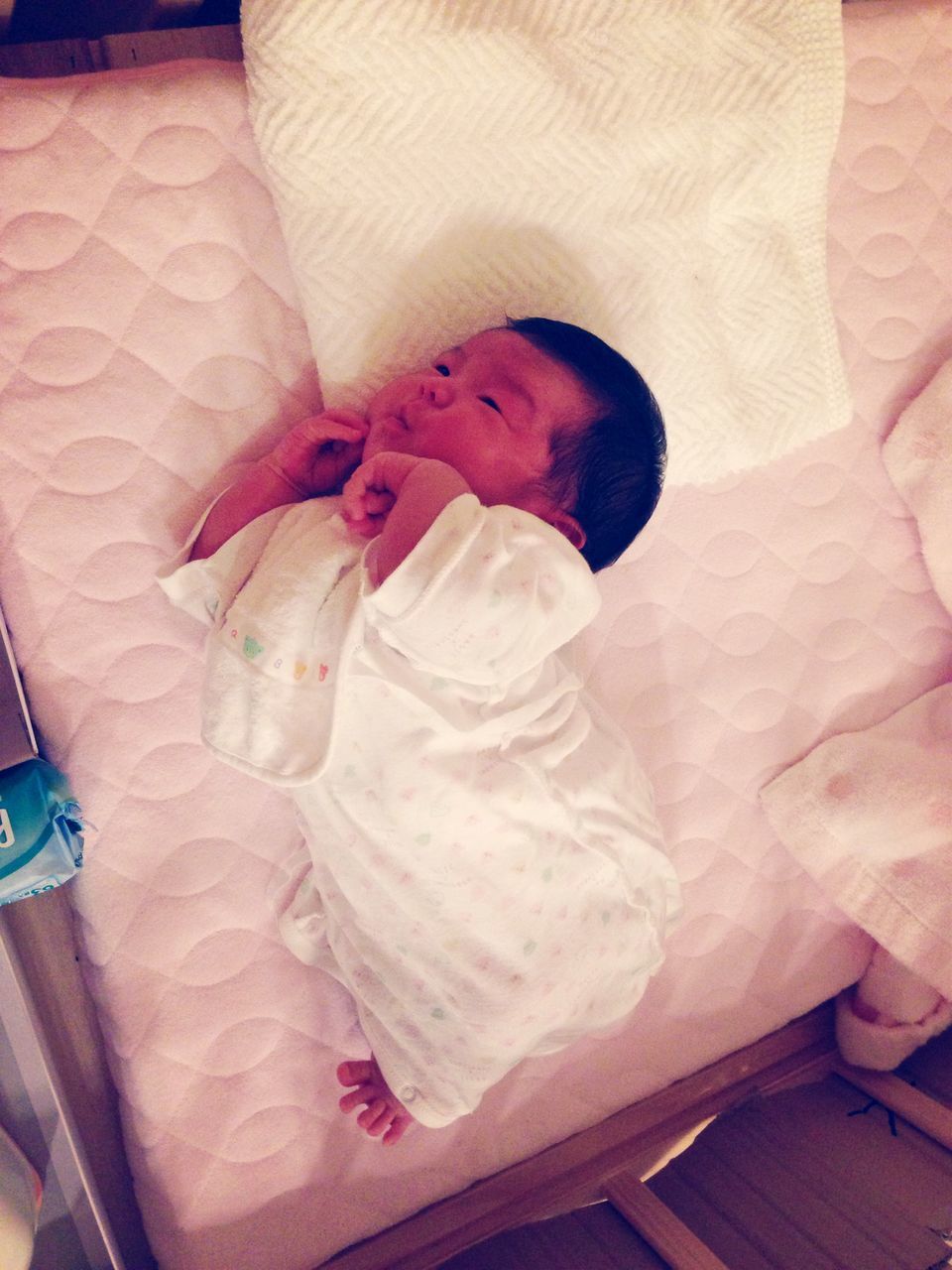 indoors, bed, high angle view, home interior, pillow, bedroom, relaxation, childhood, person, pink color, cute, babyhood, baby, blanket, full length, toddler, innocence, sitting