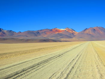 Barren landscape against mountain range