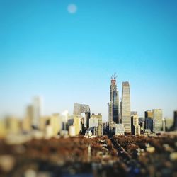 View of cityscape against blue sky