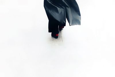 Low section of woman standing on white background