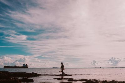 Man on beach against sky