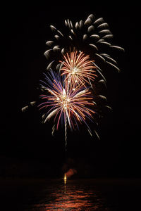 Low angle view of firework display at night