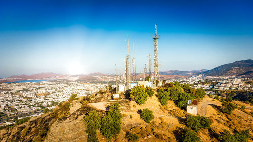 Telecommunication tower on mountin with 4g 5g cellular network antenna on city background. 