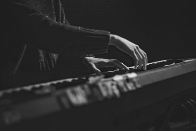 Midsection of woman playing keyboard