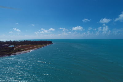 Scenic view of sea against blue sky